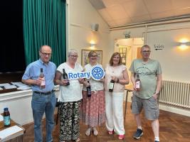 The winning team holding their prizes and the Rotary logo